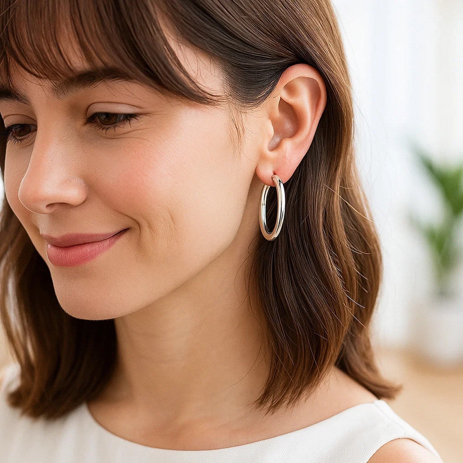 Elegant 14k white gold polished hoop earrings showcasing a sleek, refined design for timeless luxury.