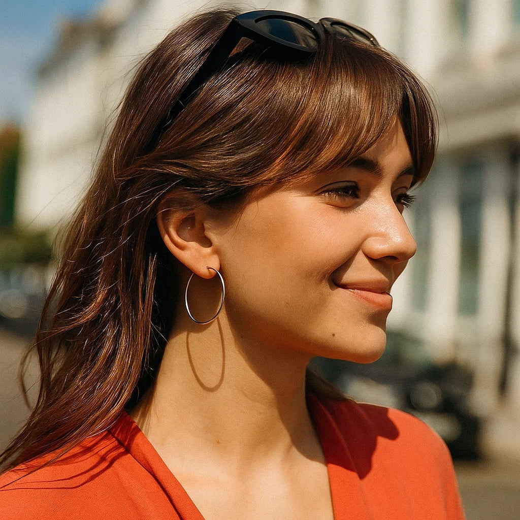 Polished 14k white gold hoop earrings with a modern design, showcasing elegance and timeless sophistication.