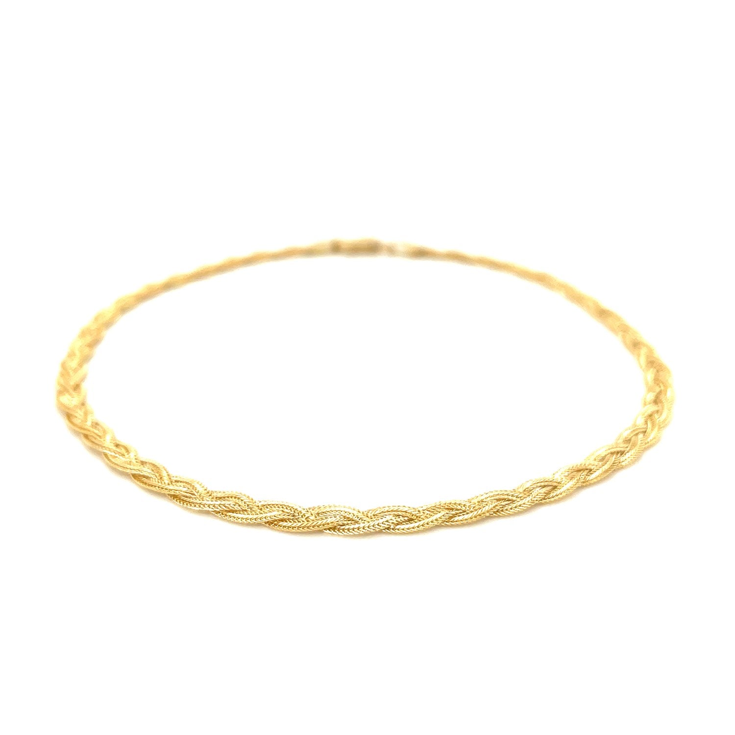 Elegant 14k yellow gold braided foxtail anklet showcasing intricate chain design for a luxurious touch.
