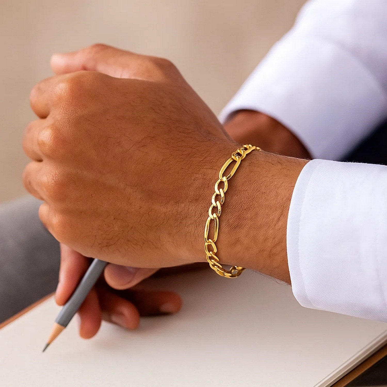 14k yellow gold Lite Figaro bracelet with modern chain links, showcasing elegance and timeless luxury.