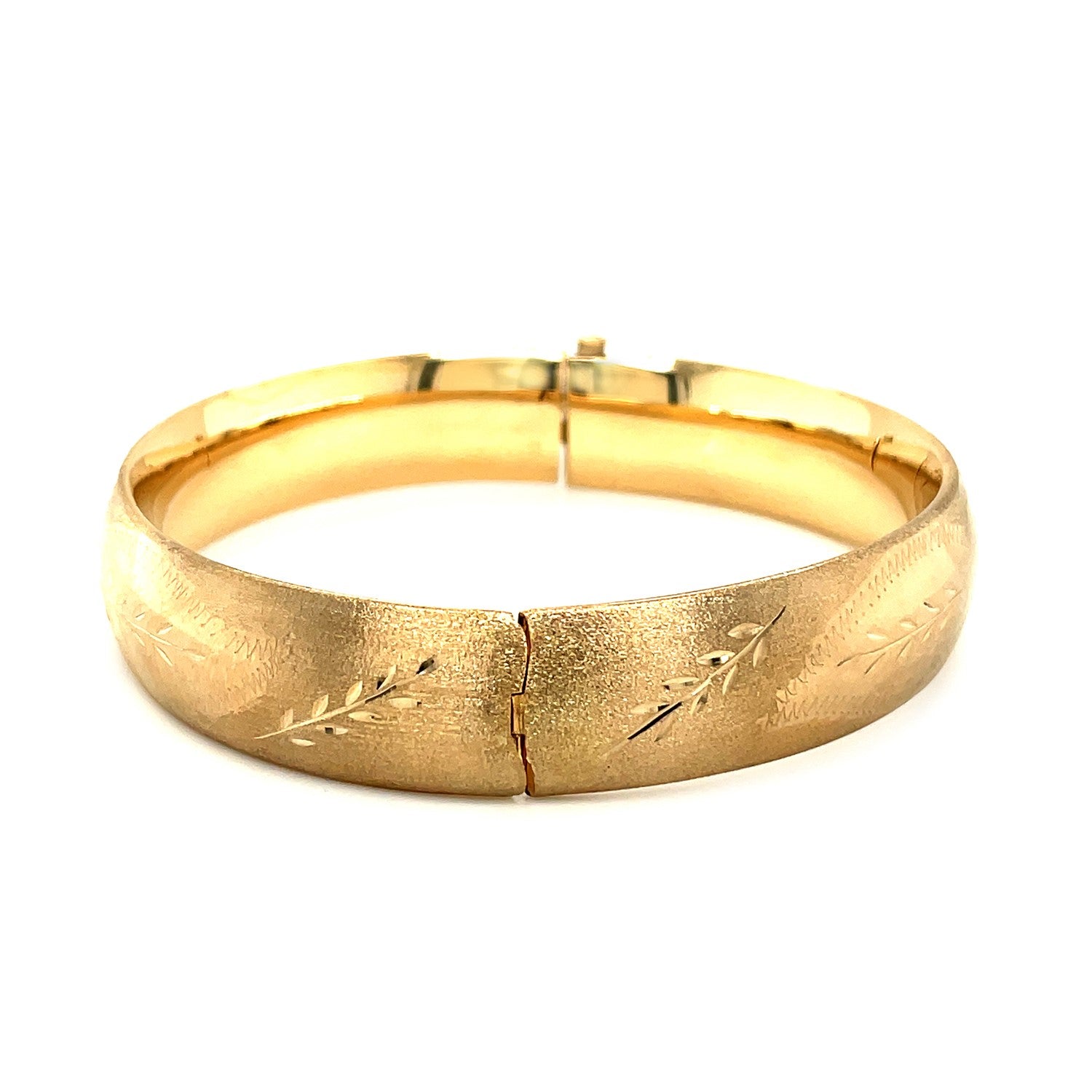 Classic floral carved bangle in 14k yellow gold, showcasing modern elegance with intricate detailing.