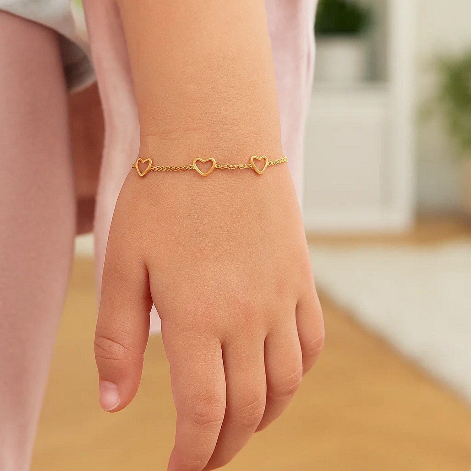 14k yellow gold children's bracelet featuring heart motifs in a minimalist design, perfect for luxury gifting.