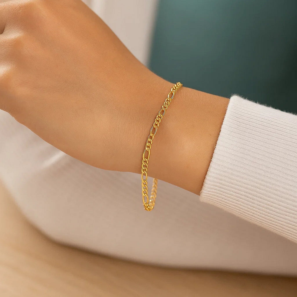 Elegant 14k yellow gold Figaro bracelet featuring a classic chain link design, perfect for luxury styling.