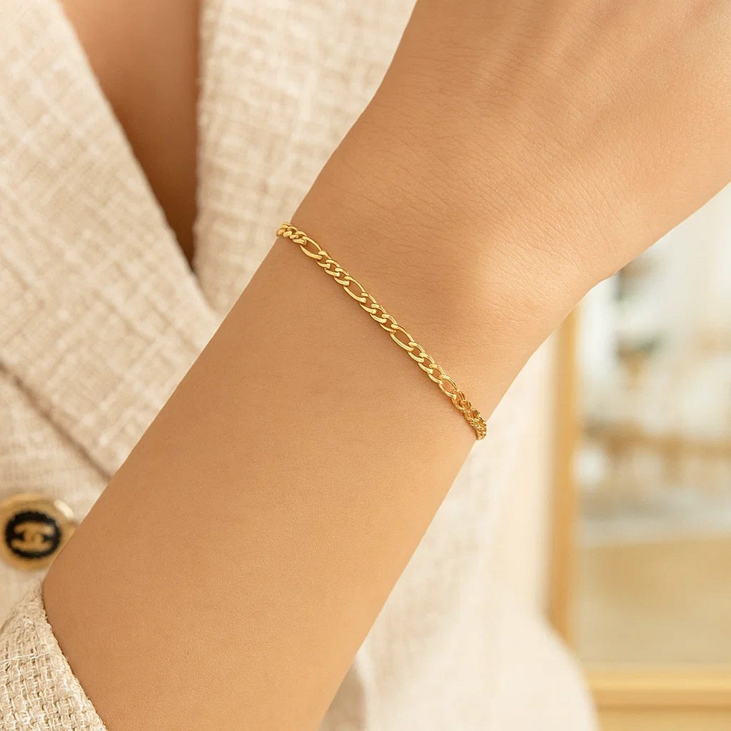 Elegant 14k yellow gold Figaro bracelet featuring a refined chain link design, perfect for luxury jewelry enthusiasts.
