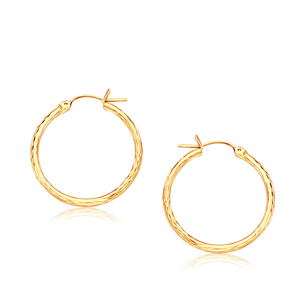 14k yellow gold slender hoop earrings with a diamond-cut finish, modern elegance for any luxury jewelry collection.