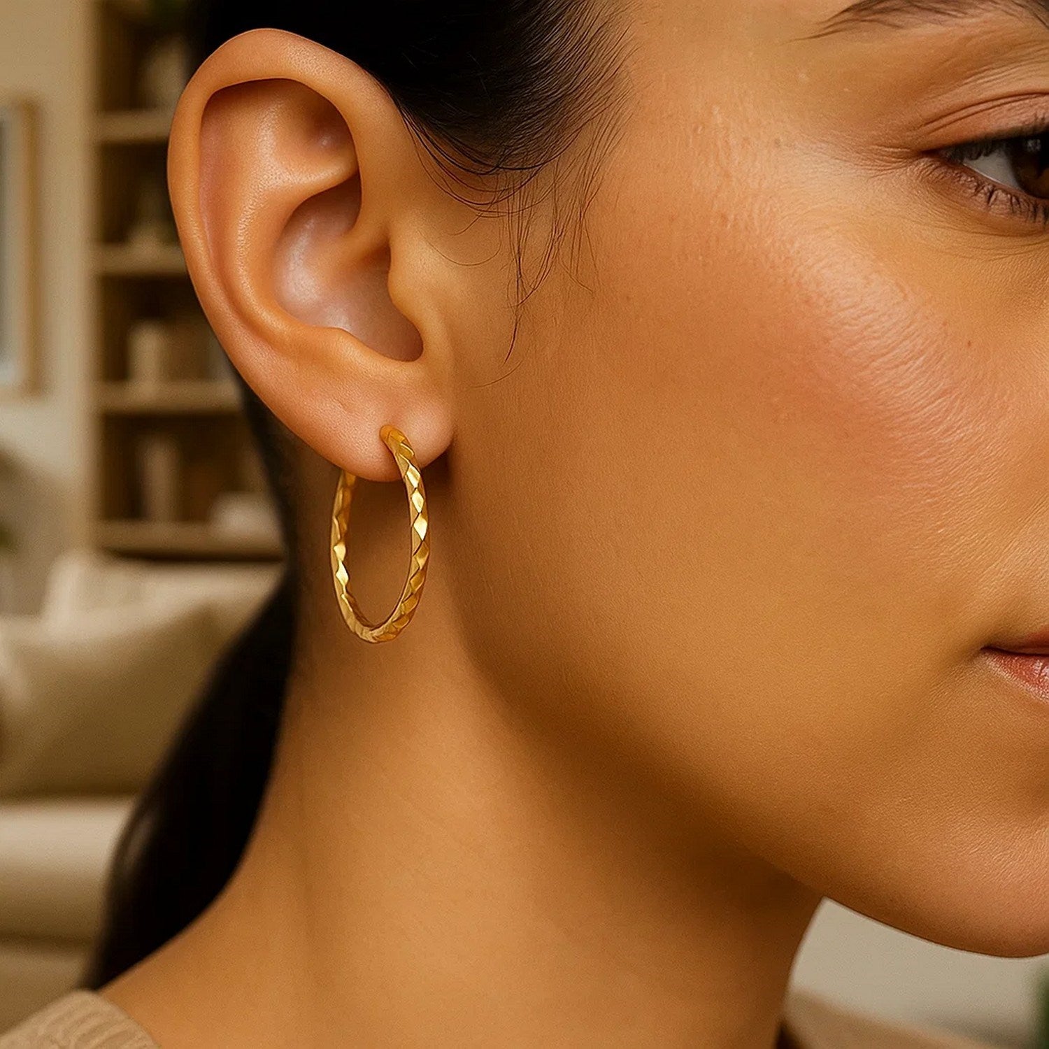 14k yellow gold slender hoop earrings with diamond-cut finish, modern design, 25mm diameter, perfect for elegant occasions.