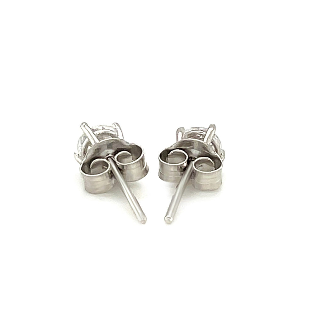 Sterling silver stud earrings featuring faceted white cubic zirconia in elegant prong settings, showcasing modern luxury.
