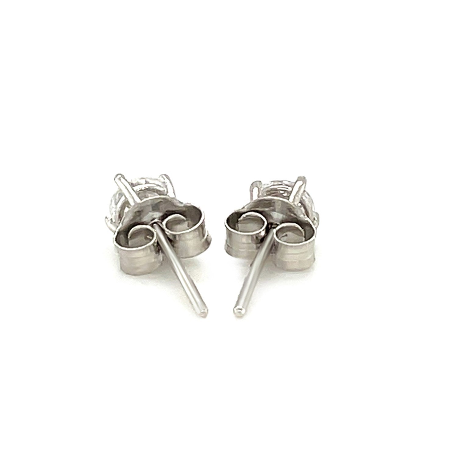 Sterling silver stud earrings featuring faceted white cubic zirconia in elegant prong settings, showcasing modern luxury.