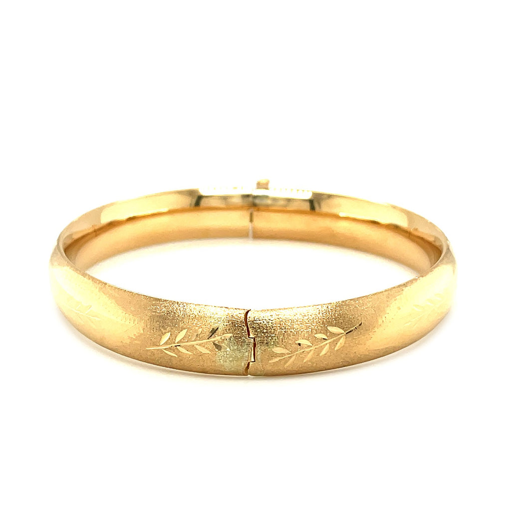 Classic floral carved bangle in 14k yellow gold, showcasing elegant design and luxurious craftsmanship.