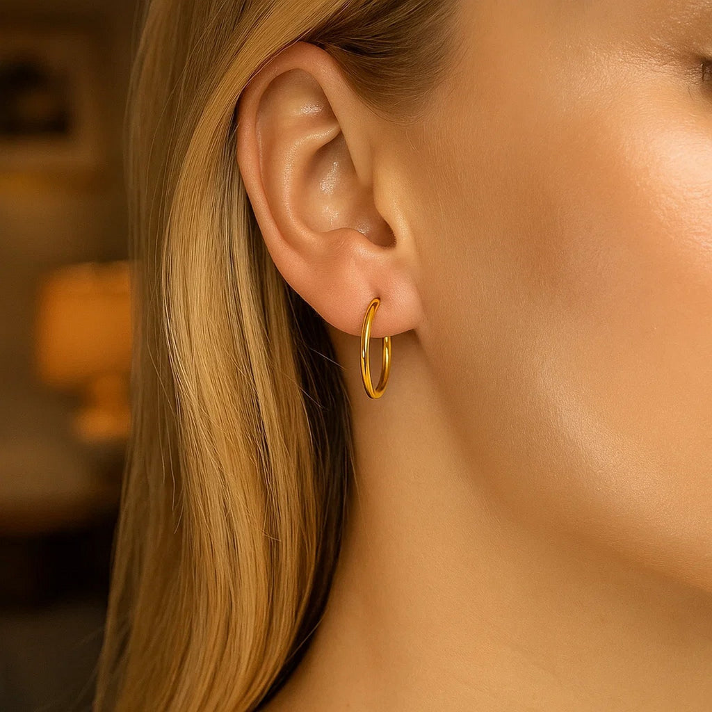 14k yellow gold polished hoop earrings with a modern design, perfect for elegant everyday wear.