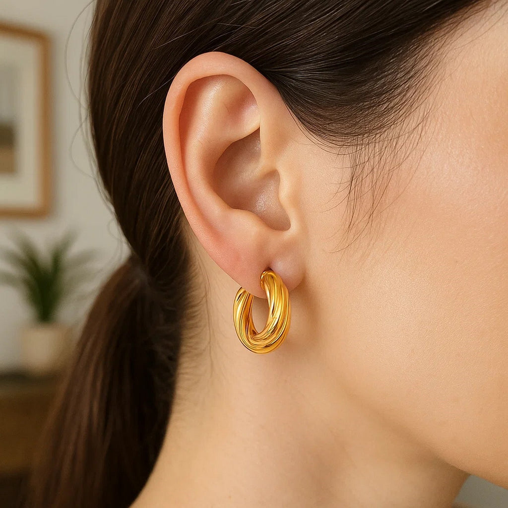 14k yellow gold modern twist hoop earrings showcasing elegant design and luxurious shine, perfect for any occasion.