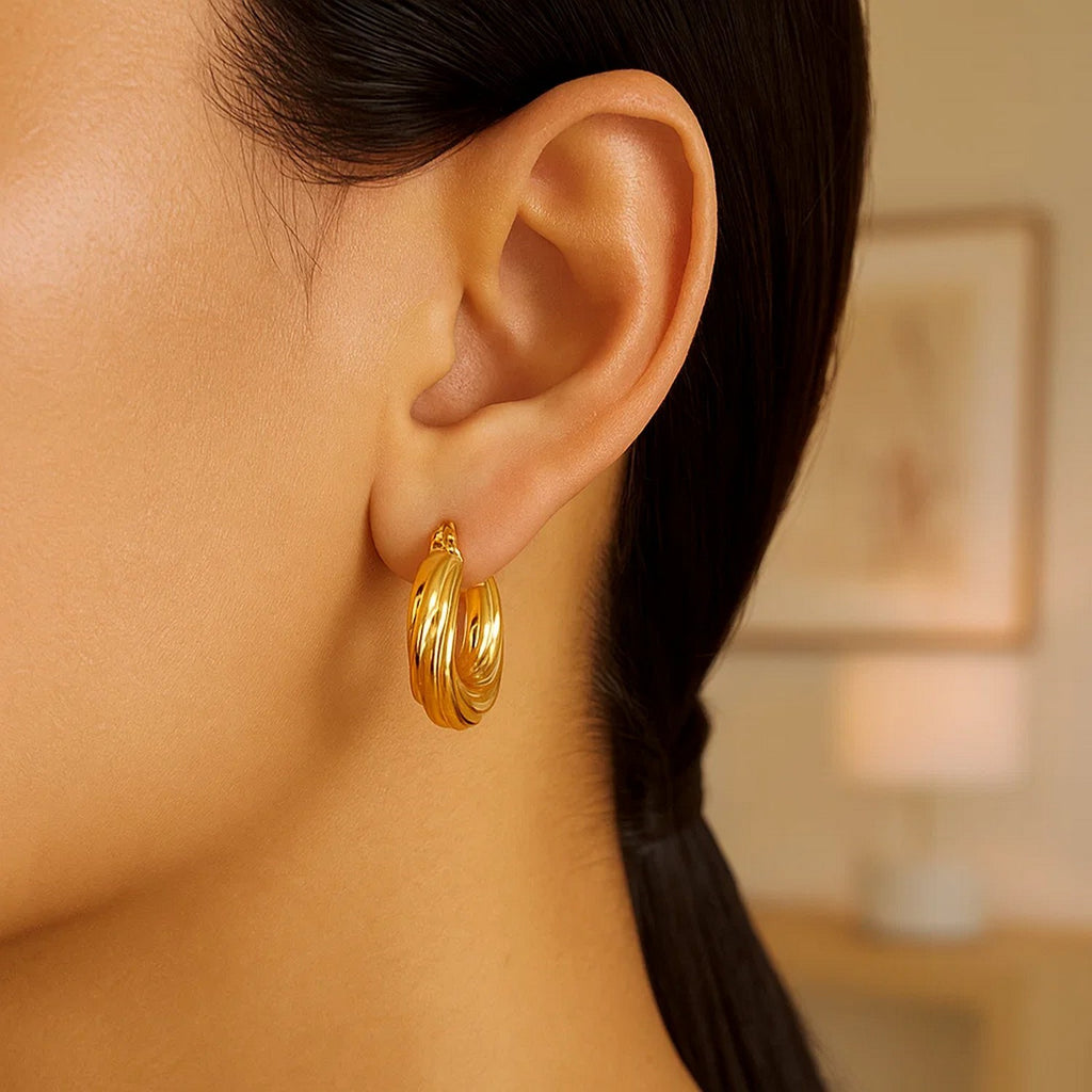 14k yellow gold modern twist hoop earrings showcasing a sleek, elegant design for a luxurious touch.
