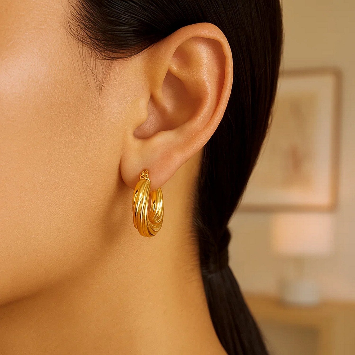 14k yellow gold modern twist hoop earrings showcasing a sleek, elegant design for a luxurious touch.
