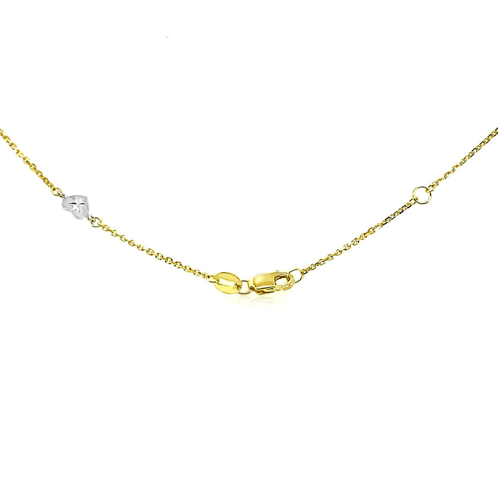 14k two-tone gold anklet featuring diamond cut heart style stations, minimalist design with elegant chain and stud accents.