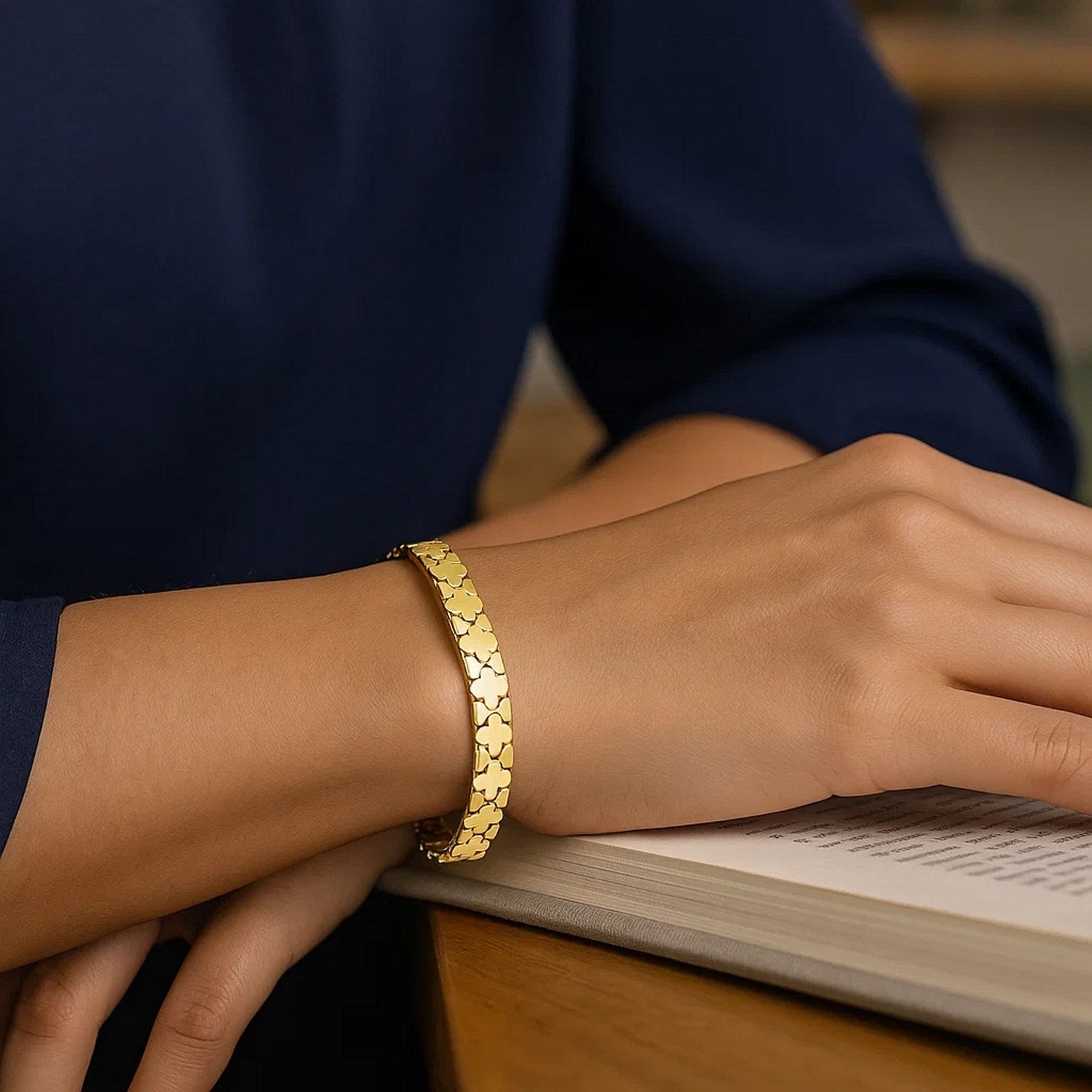 Nature-inspired 14k yellow gold clover bracelet featuring modern link design, showcasing elegance and craftsmanship.