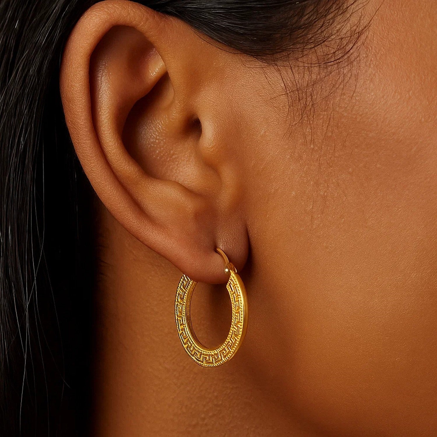 14k yellow gold medium hoop earrings featuring a modern Greek key design, perfect for elegant everyday wear.