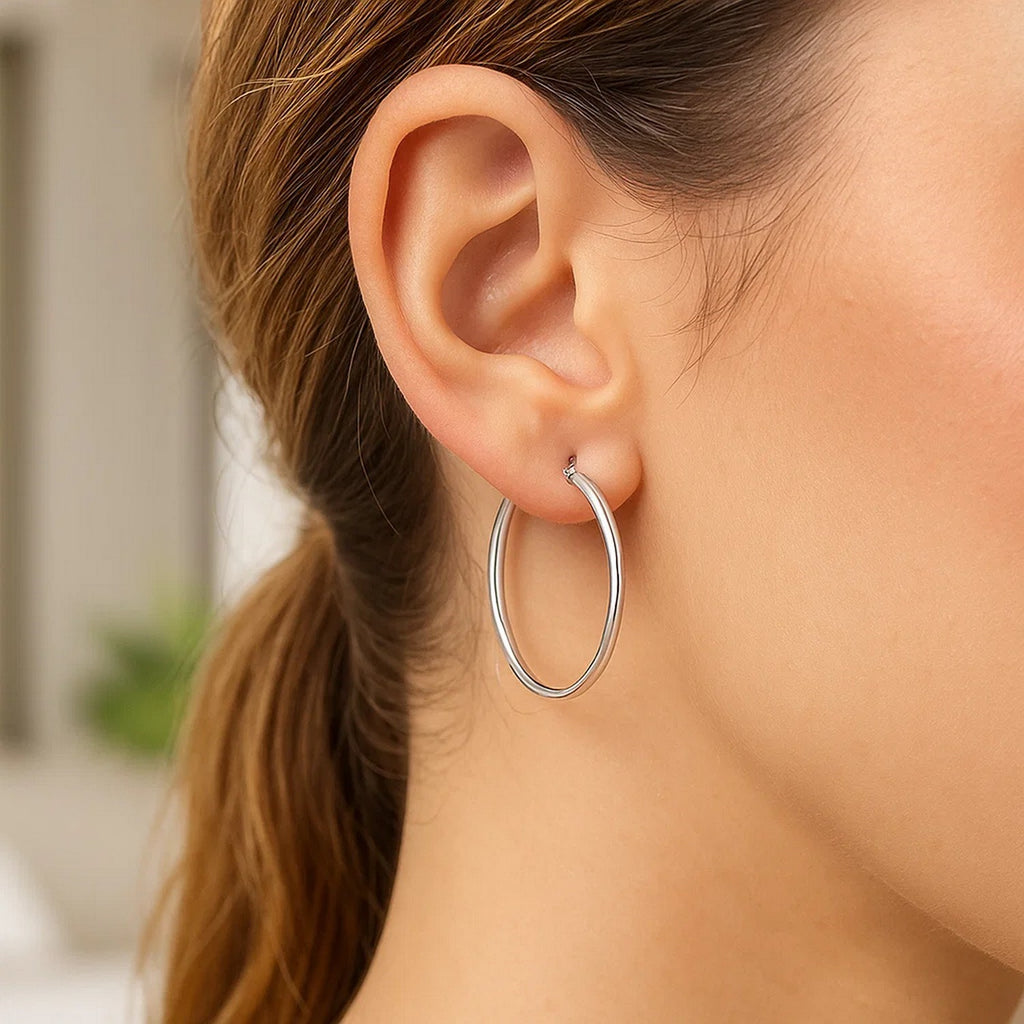 Elegant 14k white gold polished hoop earrings showcasing a sleek, modern design for refined luxury.