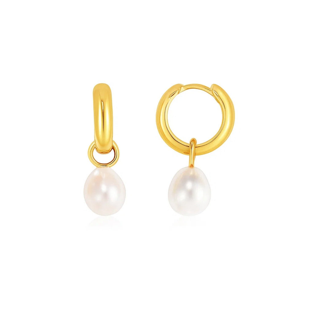 14k yellow gold hoop huggie earrings adorned with lustrous pearls, showcasing a modern and elegant design.