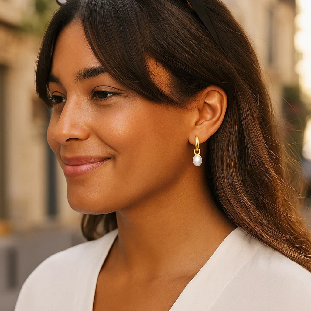 14k yellow gold pearl hoop huggie earrings featuring a modern design and elegant round shape for sophisticated style.