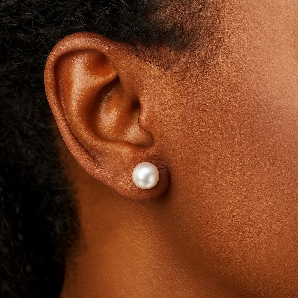14k yellow gold stud earrings featuring lustrous freshwater cultured white pearls in a modern round design.