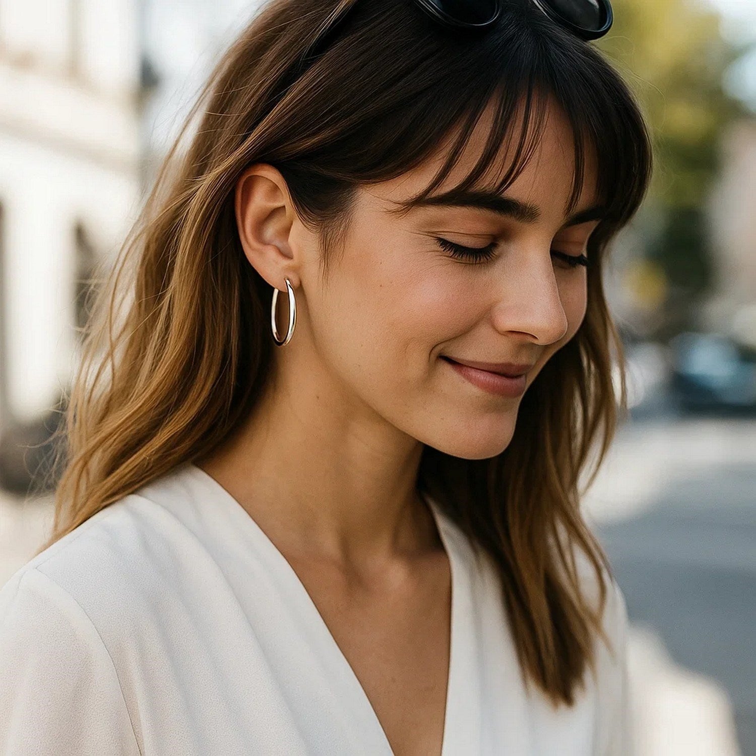 14k white gold polished hoop earrings showcasing a modern design with a sleek, elegant finish.