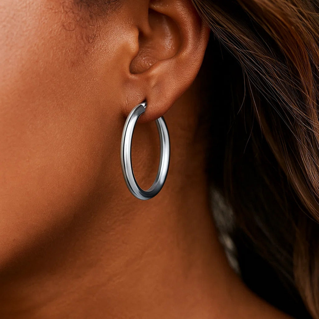 14k white gold polished hoop earrings showcasing a sleek modern design, perfect for elegant everyday wear.