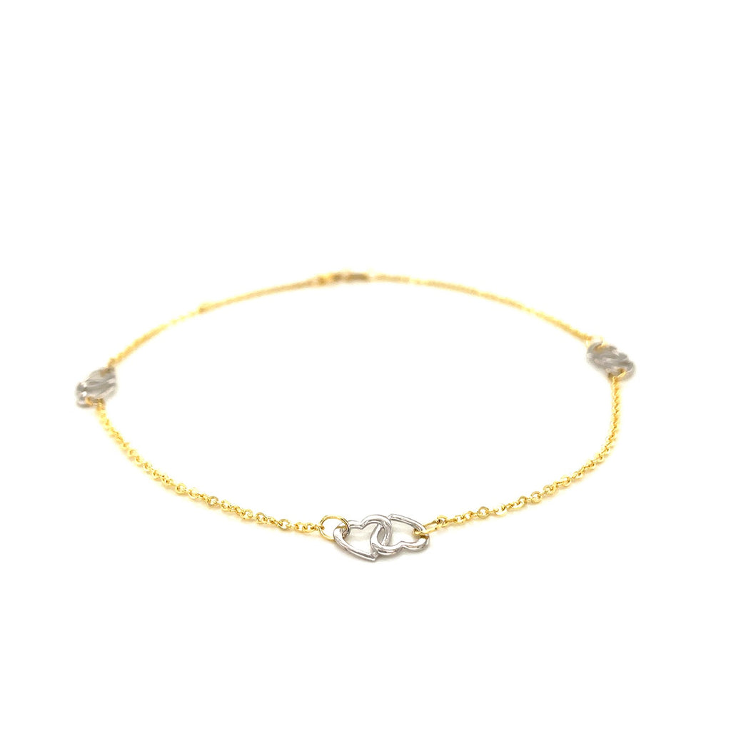 14k two-tone gold entwined heart anklet with modern design, showcasing luxurious craftsmanship and elegant style.
