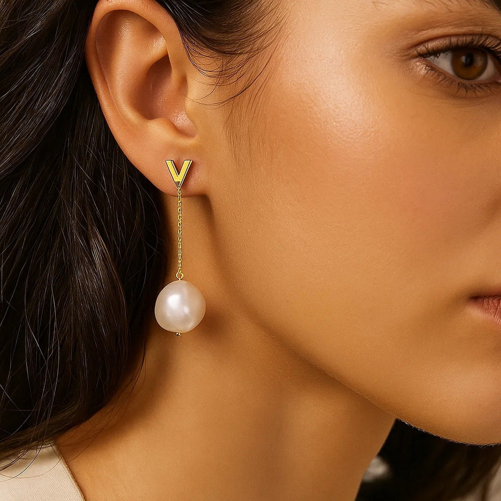 Elegant 14k yellow gold pearl drop earrings featuring a refined stud design for timeless luxury.