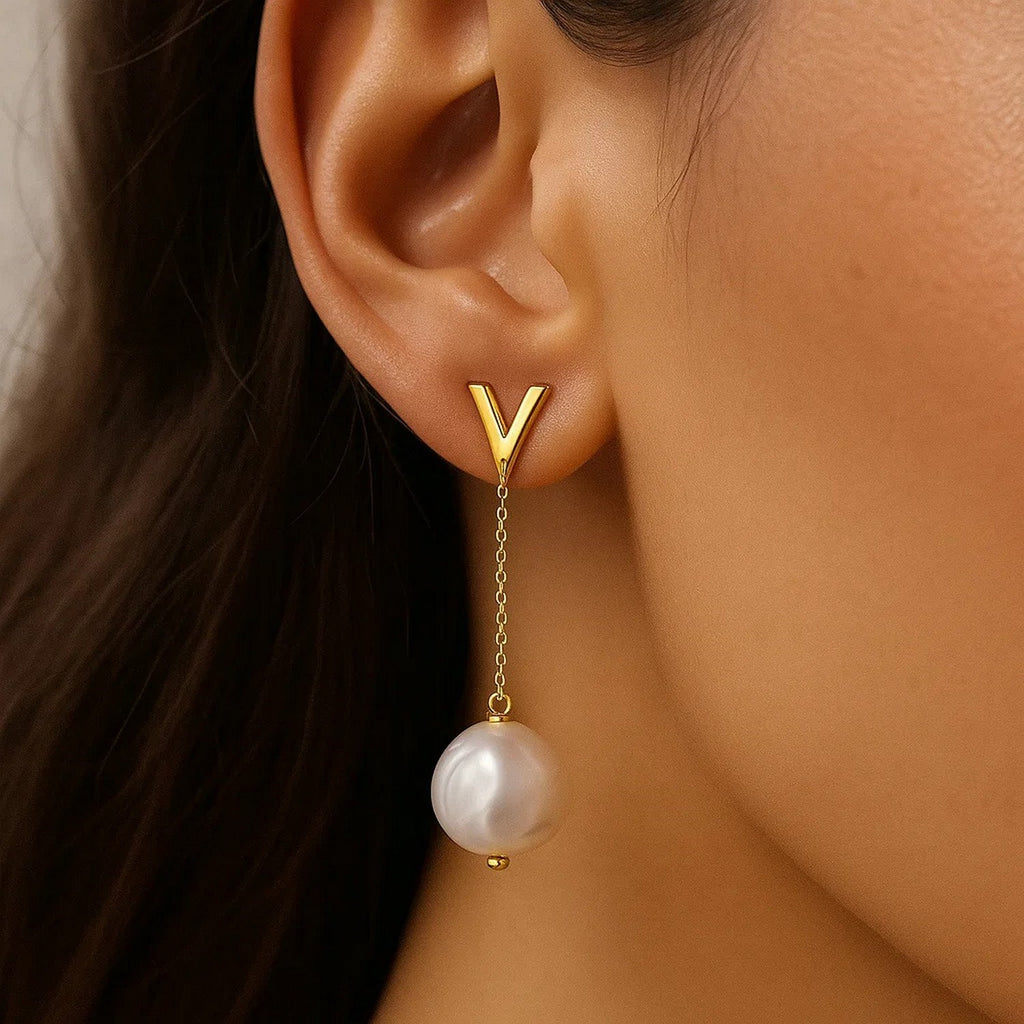 14k yellow gold elegant pearl drop earrings featuring a chic stud design and graceful drop silhouette.
