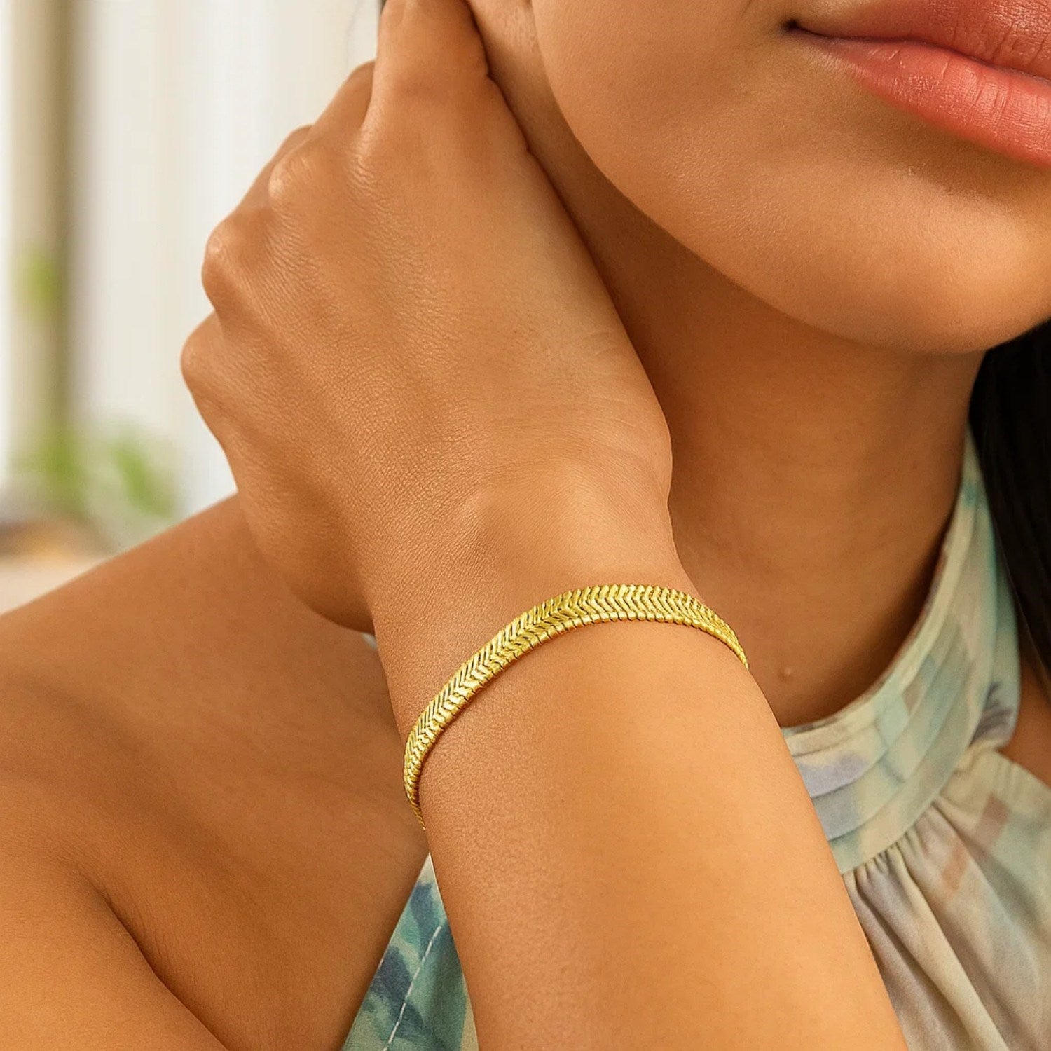 14k yellow gold oval snake chain bracelet with a modern design, showcasing a sleek 5.30 mm width for elegant wear.