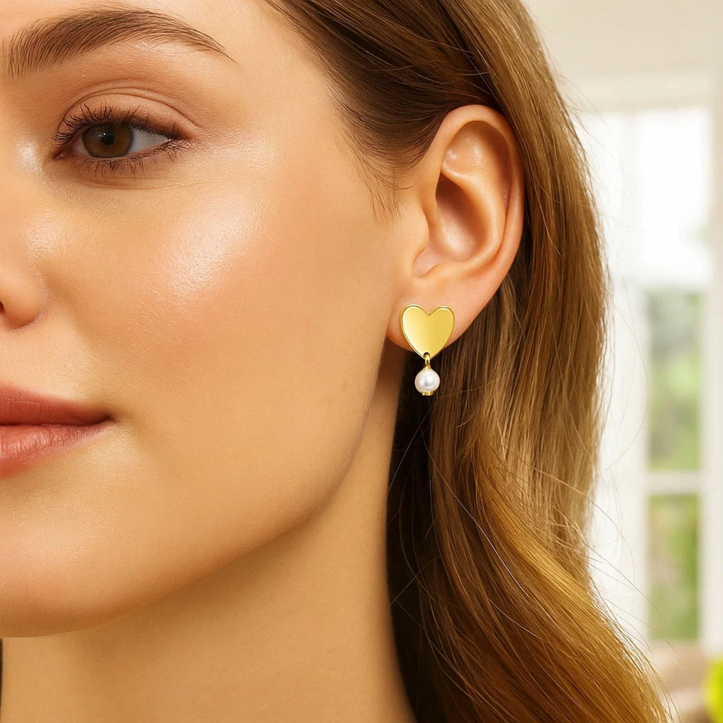 Elegant 14k yellow gold pearl drop stud earrings showcasing a refined round design for timeless luxury.