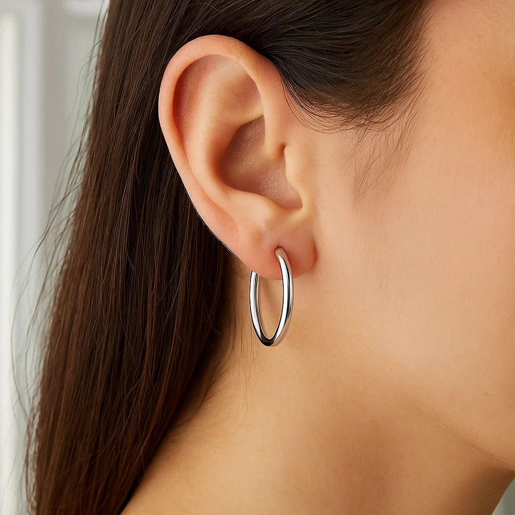 Polished 10k white gold hoop earrings in modern design, crafted from luxurious 14k gold for timeless elegance.