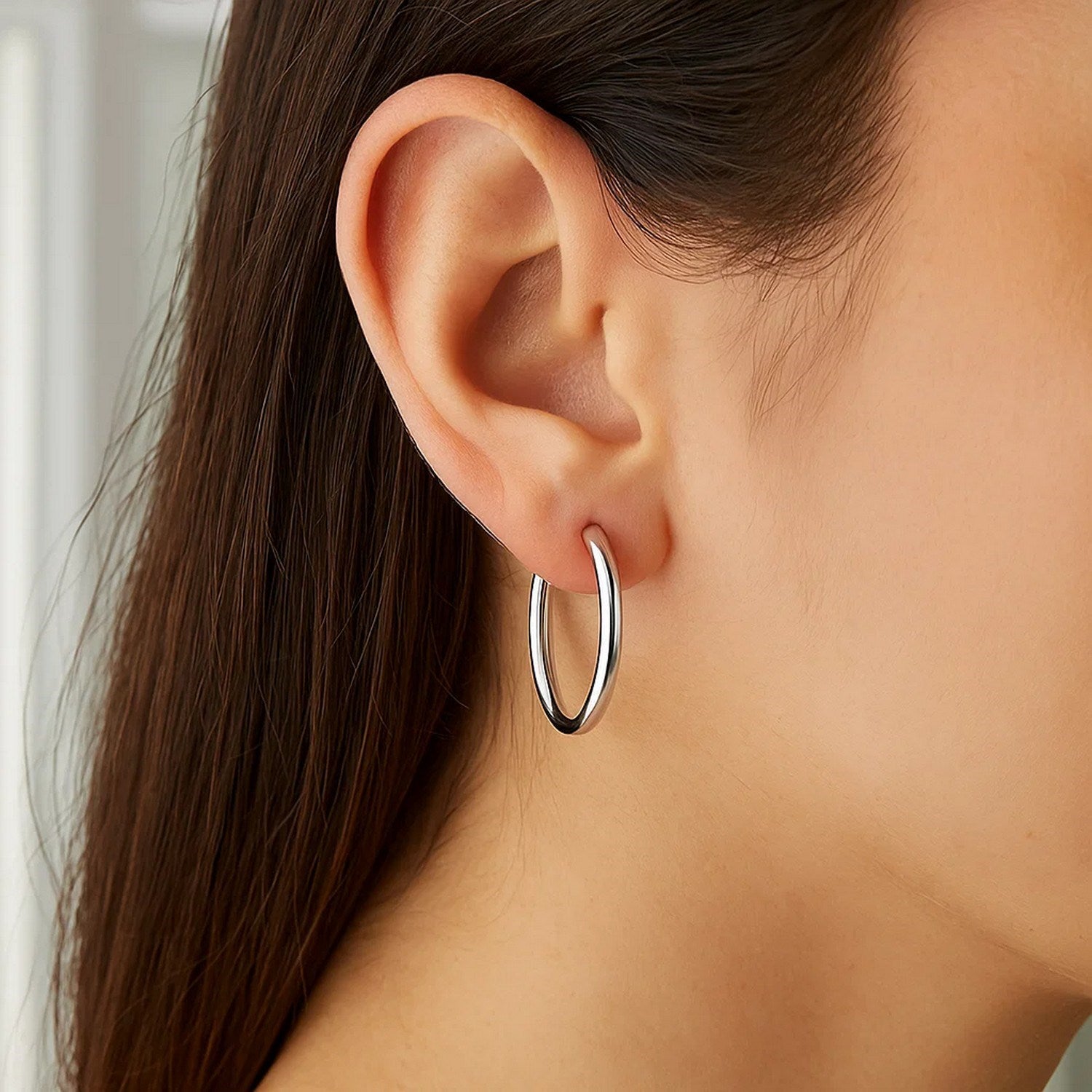 Polished 10k white gold hoop earrings in modern design, crafted from luxurious 14k gold for timeless elegance.