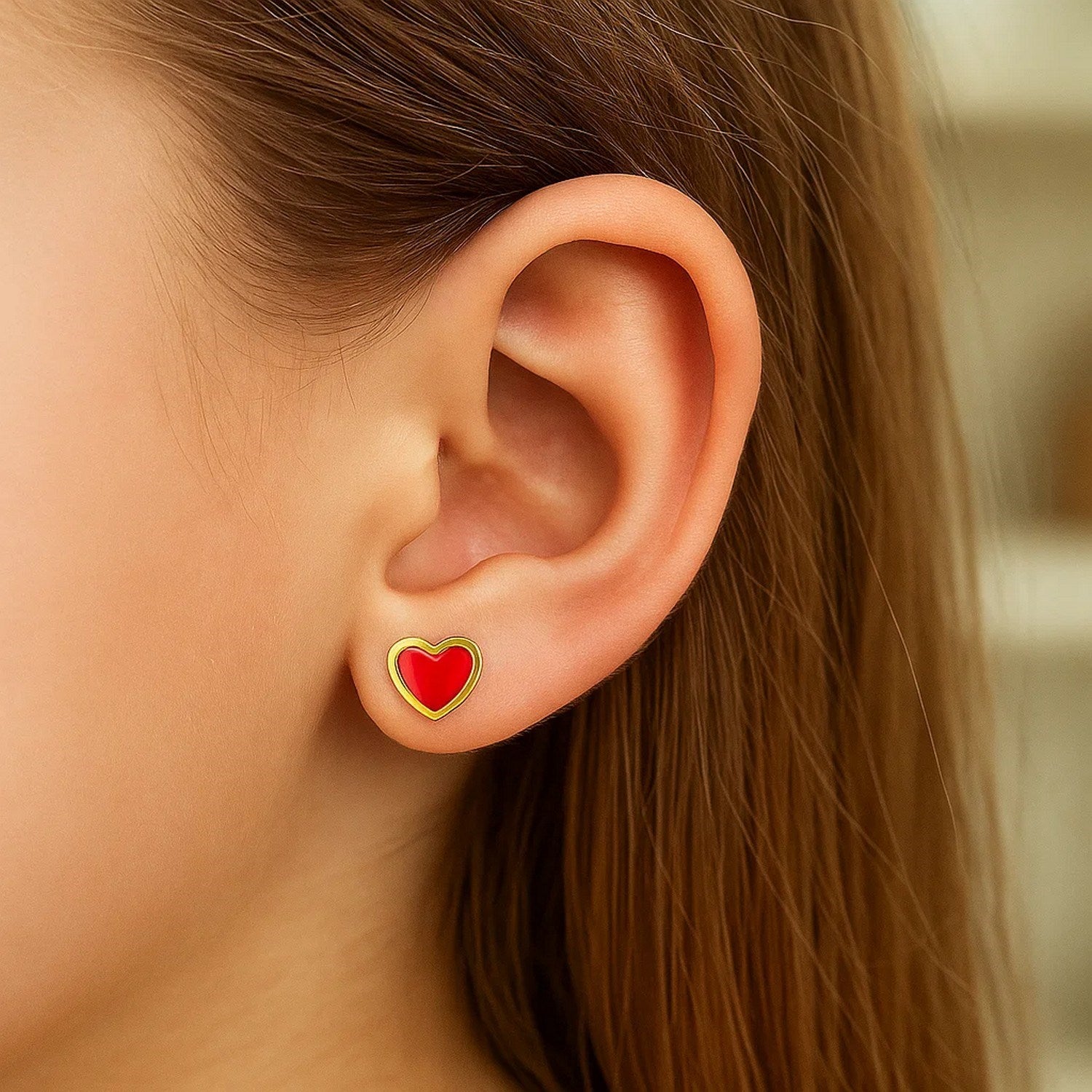 14k yellow gold stud earrings featuring modern red enamel heart design, perfect for a chic statement look.