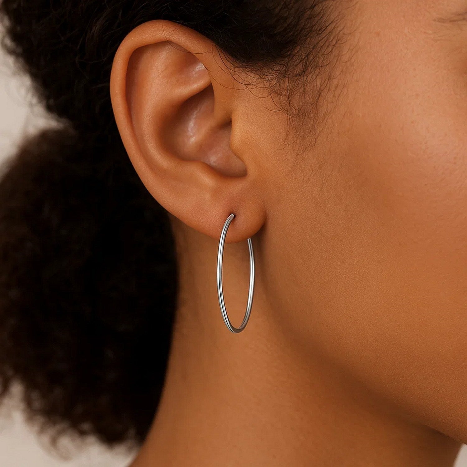 14k white gold polished hoop earrings with a sleek minimalist design, perfect for elegant everyday wear.