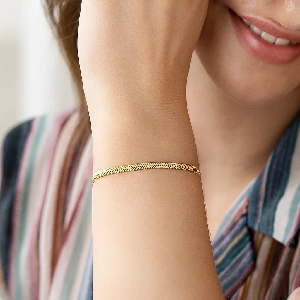 Elegant 14k yellow gold oval snake chain bracelet, showcasing a refined 2.60 mm design for timeless luxury.