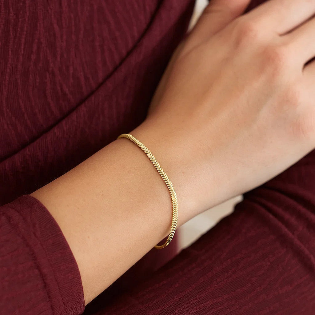 14K yellow gold oval snake chain bracelet, elegantly designed with a smooth, refined finish for timeless luxury.