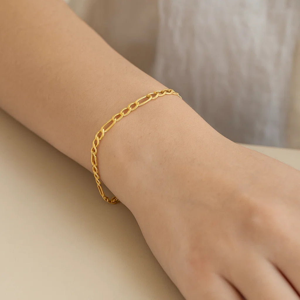10k yellow gold Lite Figaro bracelet featuring sleek links and a modern design, perfect for luxury jewelry lovers.