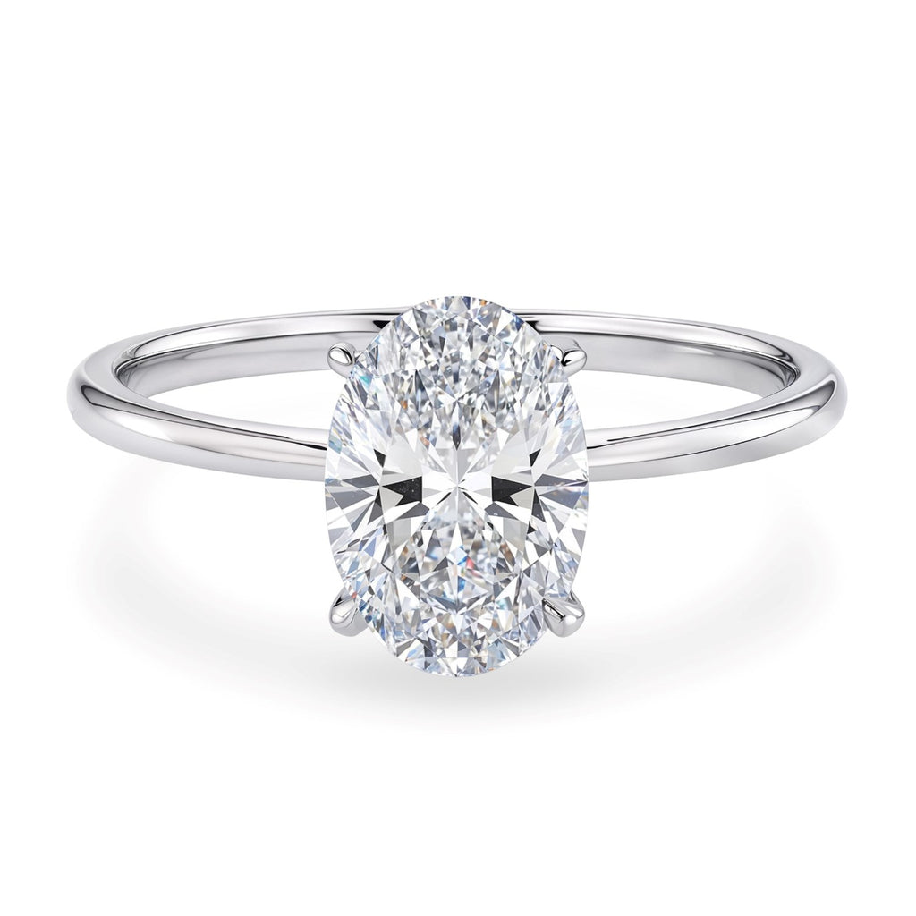 1 1/2 carat oval lab-grown diamond solitaire ring in 10K white gold with elegant prong setting, showcasing modern luxury.