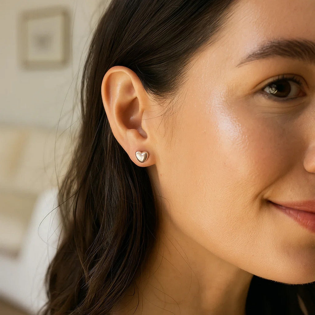 Polished 14k white gold minimalist puffed heart earrings showcasing elegant luxury and refined design.