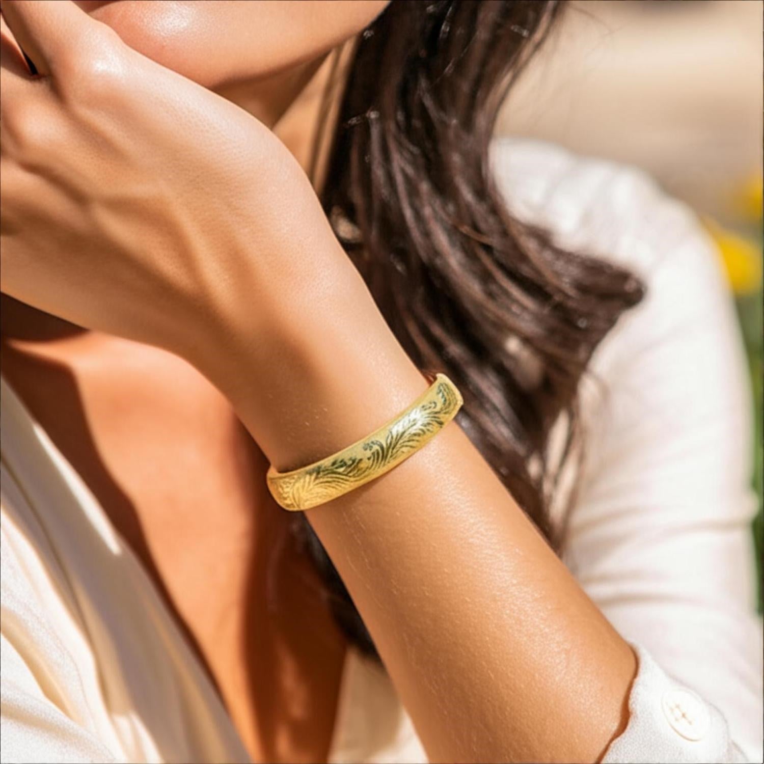 Engraved 14k yellow gold bangle featuring luxurious diamond accents, showcasing modern elegance and refined craftsmanship.