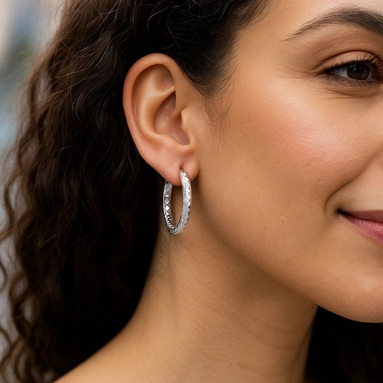 Sterling silver faceted hoop drop earrings with rhodium plating, showcasing modern elegance and refined craftsmanship.