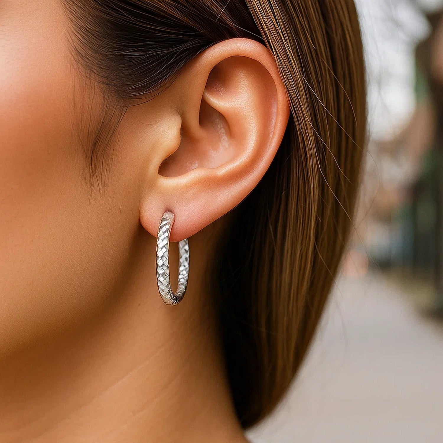 Sterling silver faceted hoop drop earrings with rhodium plating, showcasing modern elegance and refined craftsmanship.
