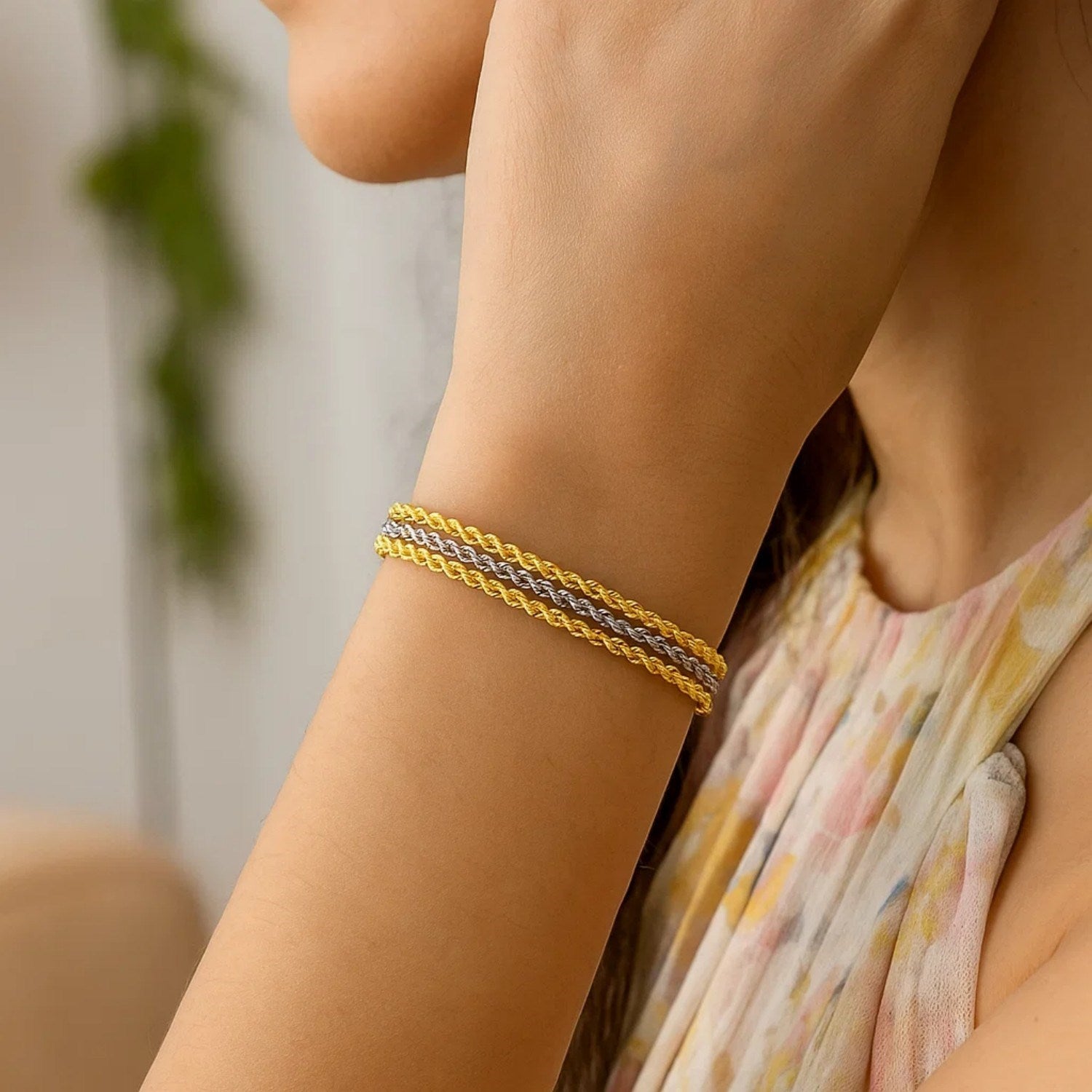 Triple strand rope chain bracelet in 10k two-tone gold, featuring modern design and luxurious 14k gold craftsmanship.