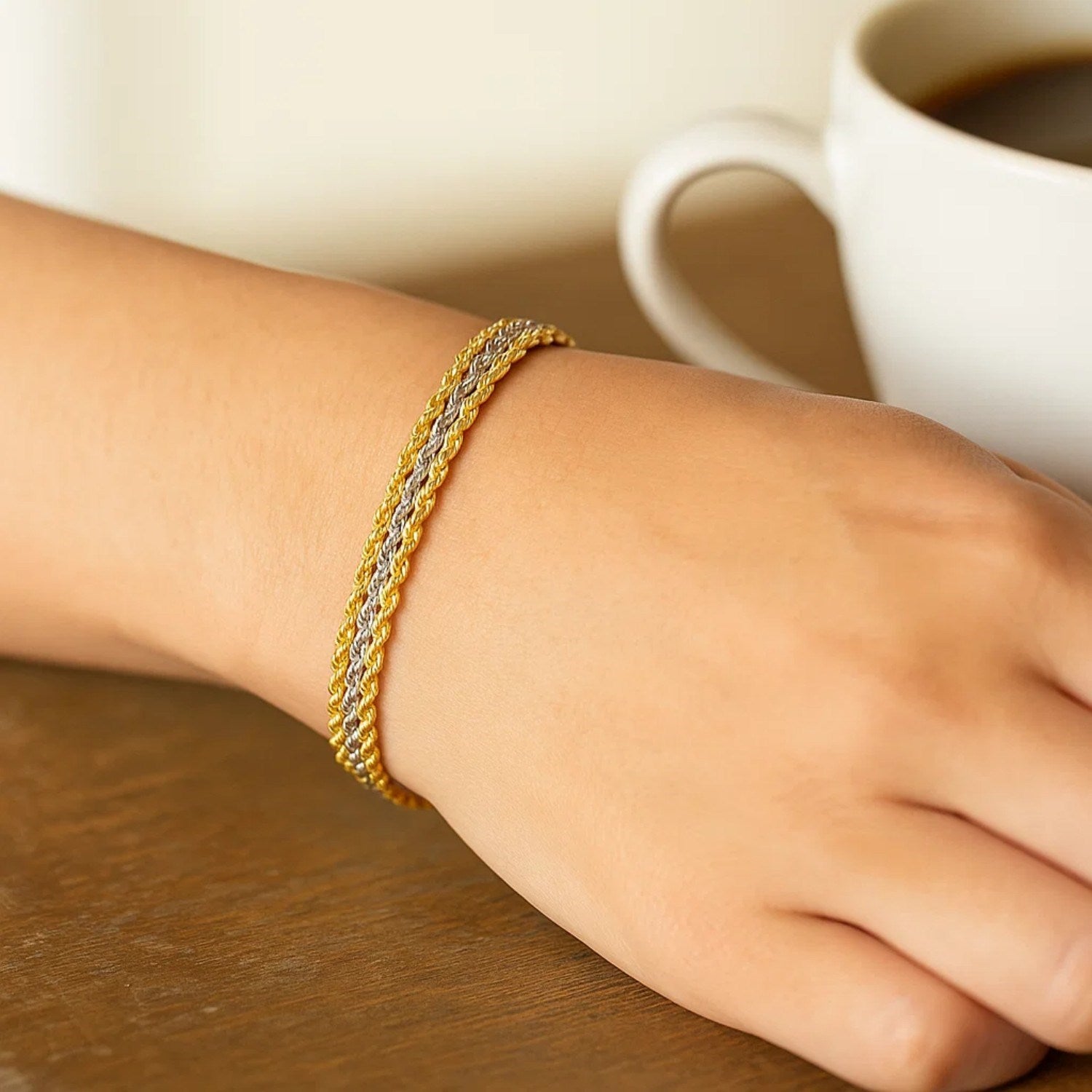 Triple strand rope chain bracelet in 10k two-tone gold, featuring modern design and luxurious 14k gold craftsmanship.