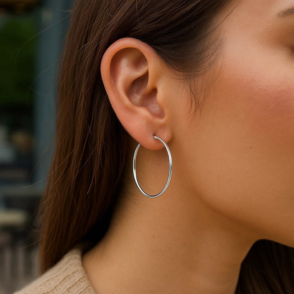Elegant 10k white gold polished hoop earrings crafted in 14k gold, showcasing a timeless and refined design.