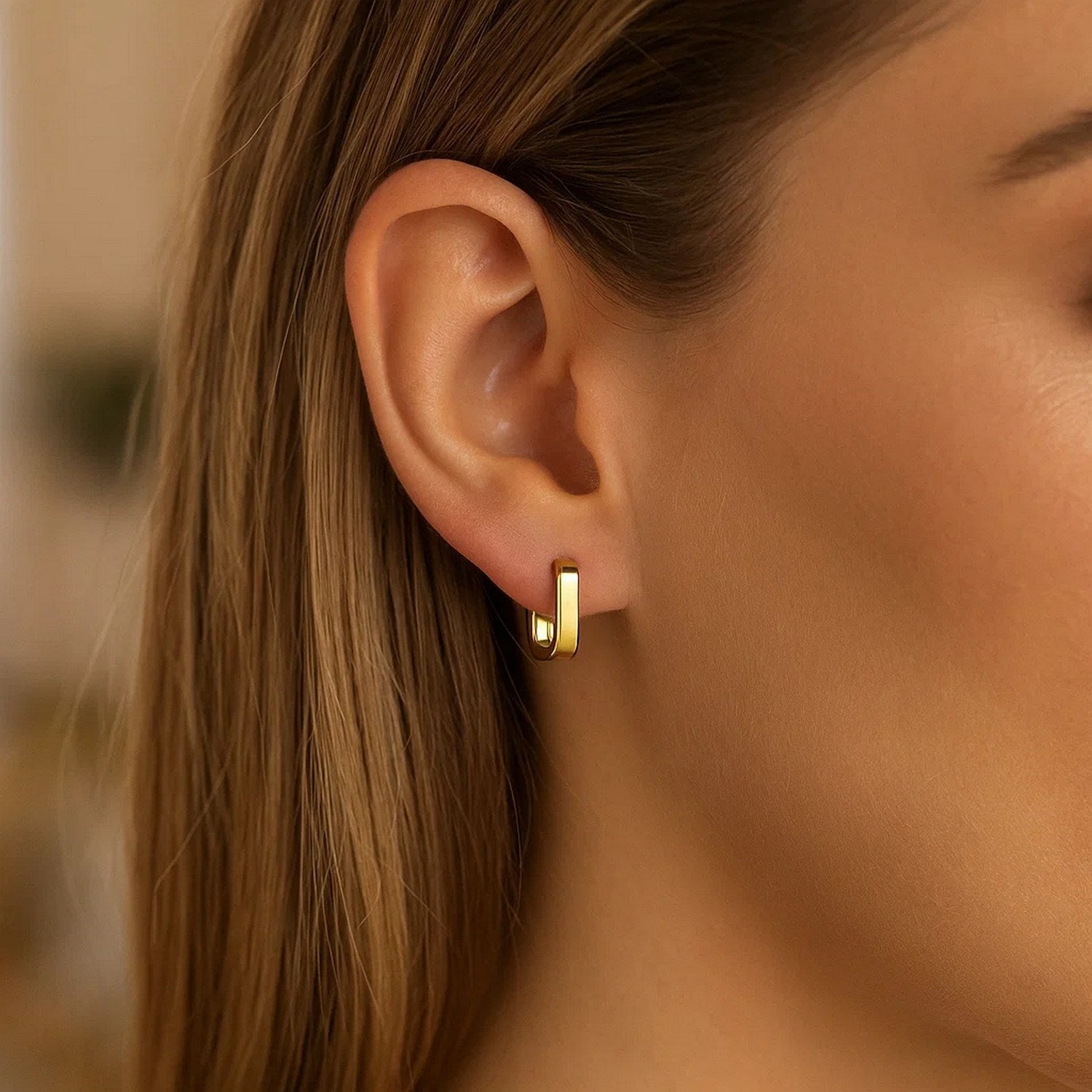 14k yellow gold small square huggie earrings with a modern design, perfect for elegant everyday wear.