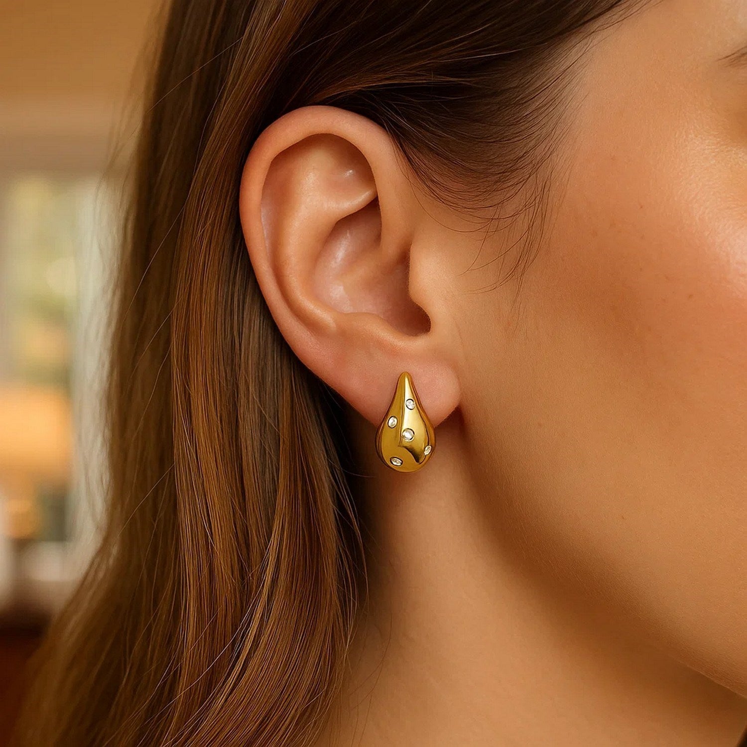 14k yellow gold polished drop earrings adorned with sparkling diamonds, showcasing a modern and elegant design.