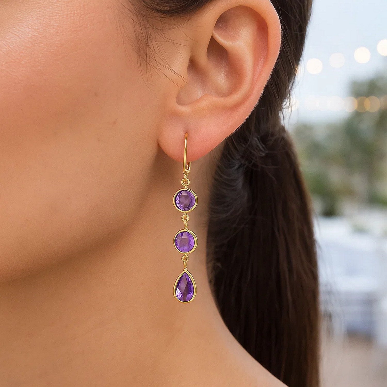 14k yellow gold drop earrings featuring round and pear-shaped amethysts in elegant bezel settings.