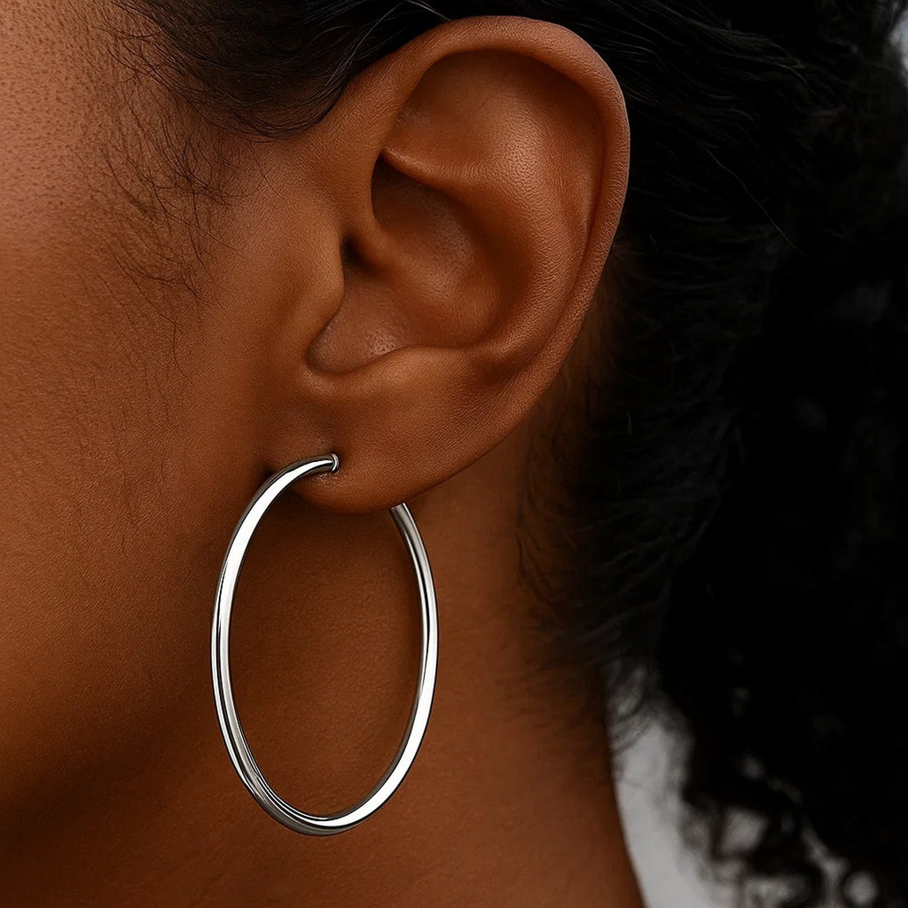Polished 10k white gold hoop earrings crafted in 14k gold, showcasing a modern design with elegant shine.